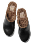 The Beek WOODPECKER clog is a black slip-on style featuring plush brown faux fur lining, shown from above on a white background.