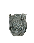 The Wavy Blue Stone Vase by Bloomingville is a round stoneware vase featuring a wavy, textured surface and a blue marbled glaze for an organic, sculptural look.