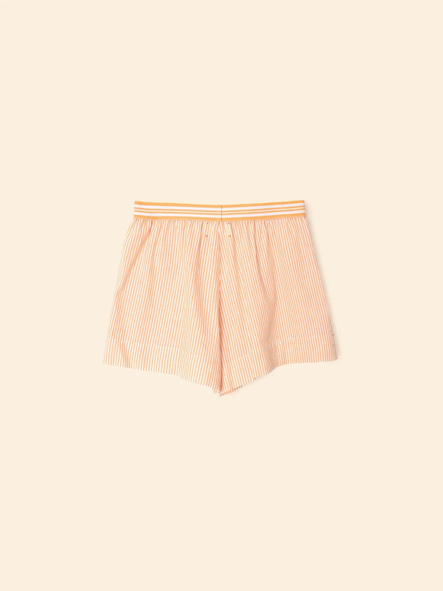 The Carlyn Short from Xirena features beige and white vertical pencil stripes in crisp cotton with an elasticized waist.