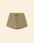 The Xirena Declan Short in light olive green cotton poplin features an elastic drawstring waist, side pockets, and cuffed hems, shown flat on a beige background.