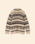 The Xirena Vail Cardigan is a beige alpaca sweater featuring black geometric and diamond-shaped patterns in horizontal rows, shown flat with the back facing up against a neutral background.