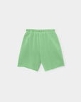The Xirena Rocco Sweatshort is a light green, vintage-washed French terry pull-on short with an elastic waistband and a simple, pocketless design. Made in Los Angeles, it's shown against a plain white background.