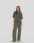 Renzo Sweatpant by Xirena styled with a loose green tee, casual look against a plain backdrop. Made in Los Angeles.