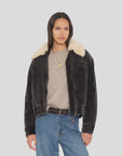 Xirena Bradley Jacket in beige paired with a cozy sweater and jeans, styled with layered necklaces for a relaxed look.