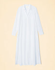 The Boden Dress by Xirena showcases a long light blue classic shirtdress with a collar and long sleeves, set against a beige background. Button fastenings enhance the tailored fit, while side slits at the hem add elegance to this cotton poplin design.