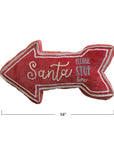 The Creative Co-op Santa Please Stop Pillow is a festive red arrow-shaped lumbar pillow, trimmed in white and embroidered with holiday text. Measuring 16" x 8.5", it adds cheerful Christmas decor to your space.