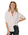 Vintage pink Zoe Shirt by Monday12 paired with black jeans, styled confidently against a bright white background.
