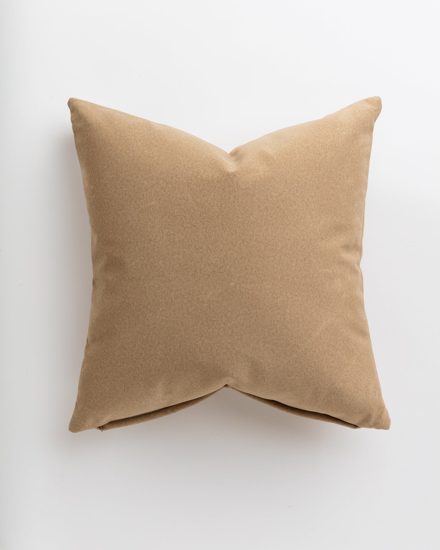 A simple Soft Camel 24x24" throw pillow with a smooth texture, showcased against a plain white background in a Scottsdale Arizona bungalow by Gabby.
