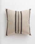 The Tri-Stripe Earth 24x24" pillow by Gabby, ideal for a cozy bungalow, is beige and square with three vertical dark grey and black stripes running down the center against a plain white background.