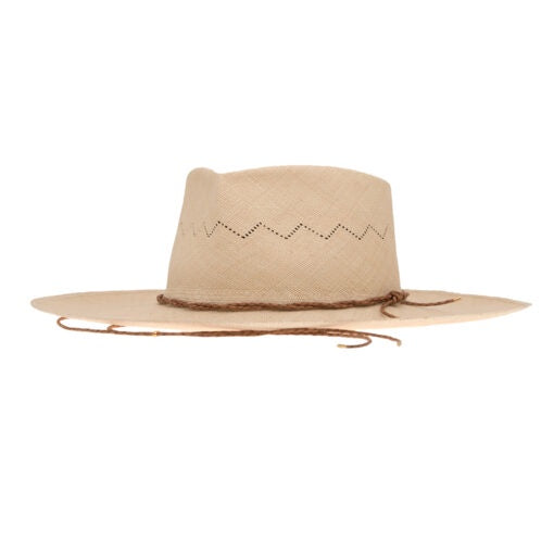 A handmade beige straw Luna hat with a wide brim and a decorative zigzag pattern around the crown, featuring a thin brown leather strap tied around it, isolated on a white background by Ninakuru.
