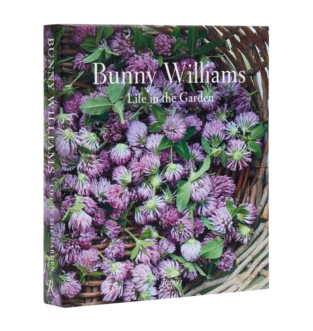 A book titled "Bunny Williams: Life in the Garden" by Random House with a cover photo showing a wicker basket filled with lush purple clover flowers and green leaves, photographed in Scottsdale, Arizona.