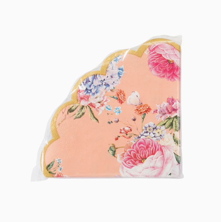 Decorative pillow with a scalloped edge, featuring a pale pink background adorned with a vibrant floral pattern in shades of pink, blue, and orange, inspired by the sunny vibes of Scottsdale Arizona from Faire's Truly Scrumptious Floral Napkins 20Pk.