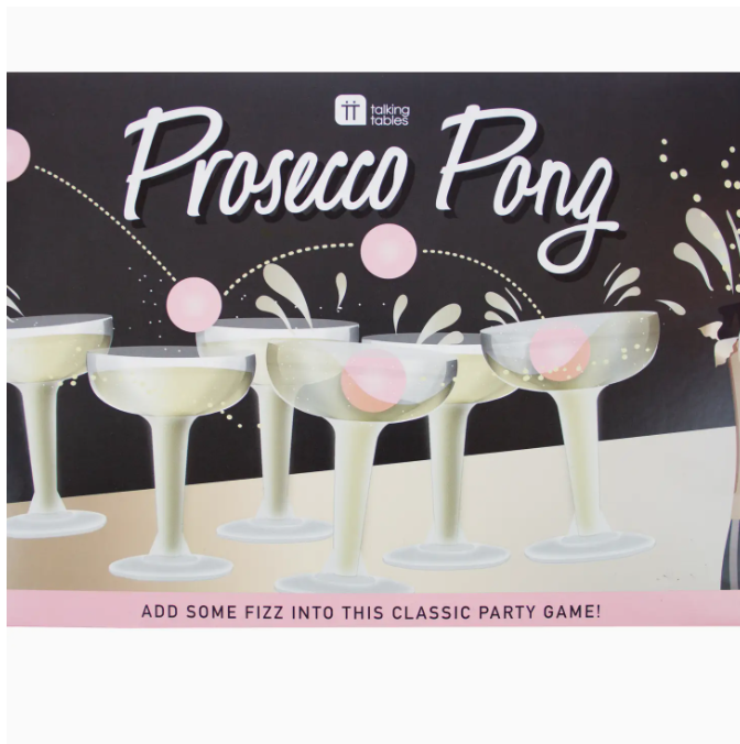Faire&#39;s Prosecco Pong Drinking Game&quot; box featuring a graphic of six champagne glasses with pink ping pong balls, set against a black background with festive white and pink confetti design and the text &quot;Add some fizz into this classic party game at your Scottsdale Arizona bungalow!&quot;.