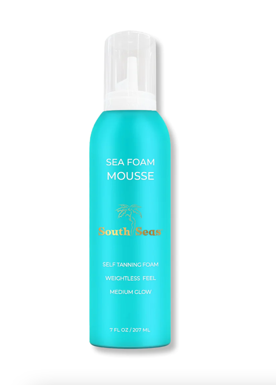 A product image of a blue bottle labeled "Sea Foam Tanning Mousse" by South Seas Skincare, photographed in a Scottsdale, Arizona bungalow, described as a self-tanning foam with a weightless feel, providing a medium glow, containing 7 fl oz / 207 mL.