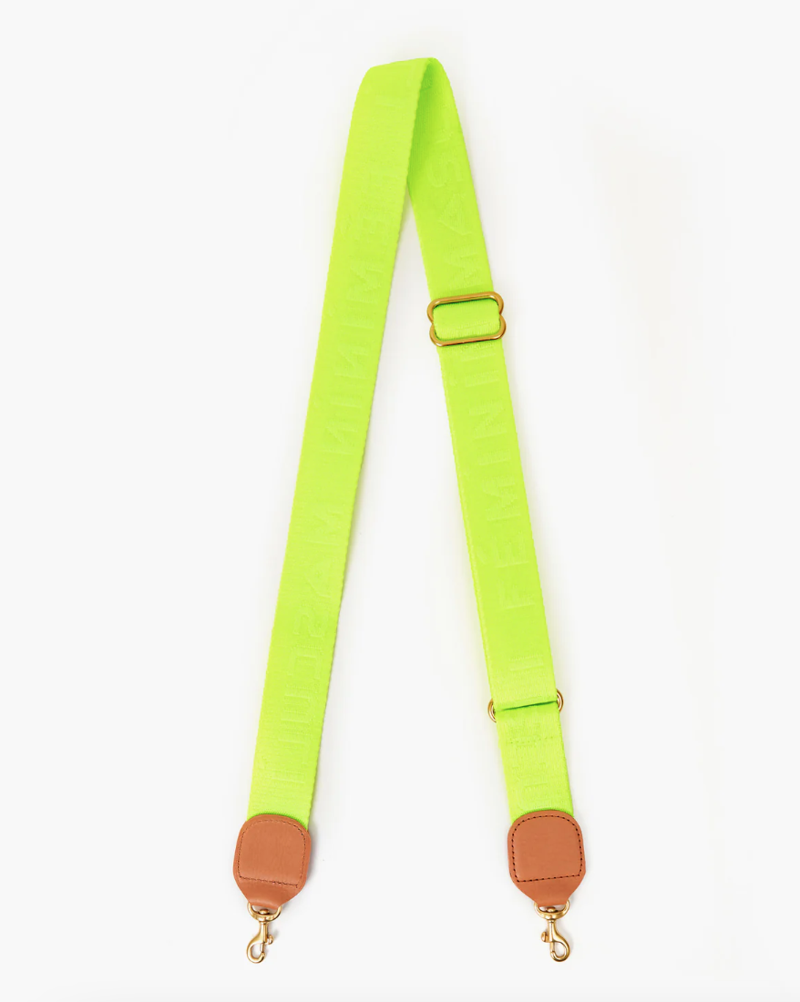 A bright neon green Clare Vivier crossbody strap with Arizona style brown leather attachments and metal clasps on a white background.