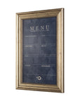 A framed Menu Art board by Mercana with decorative golden edges, featuring sections labeled "Hors d'oeuvres," "Soup," "Appetizer," "Salad," "Main," "Dessert," and "Mignardise" on a textured dark blue background, displayed in a Scottsdale
