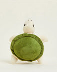The Turtle Warmies Junior by Faire is a microwavable plush turtle with a green shell and beige limbs and head, shown standing upright against a plain light background.