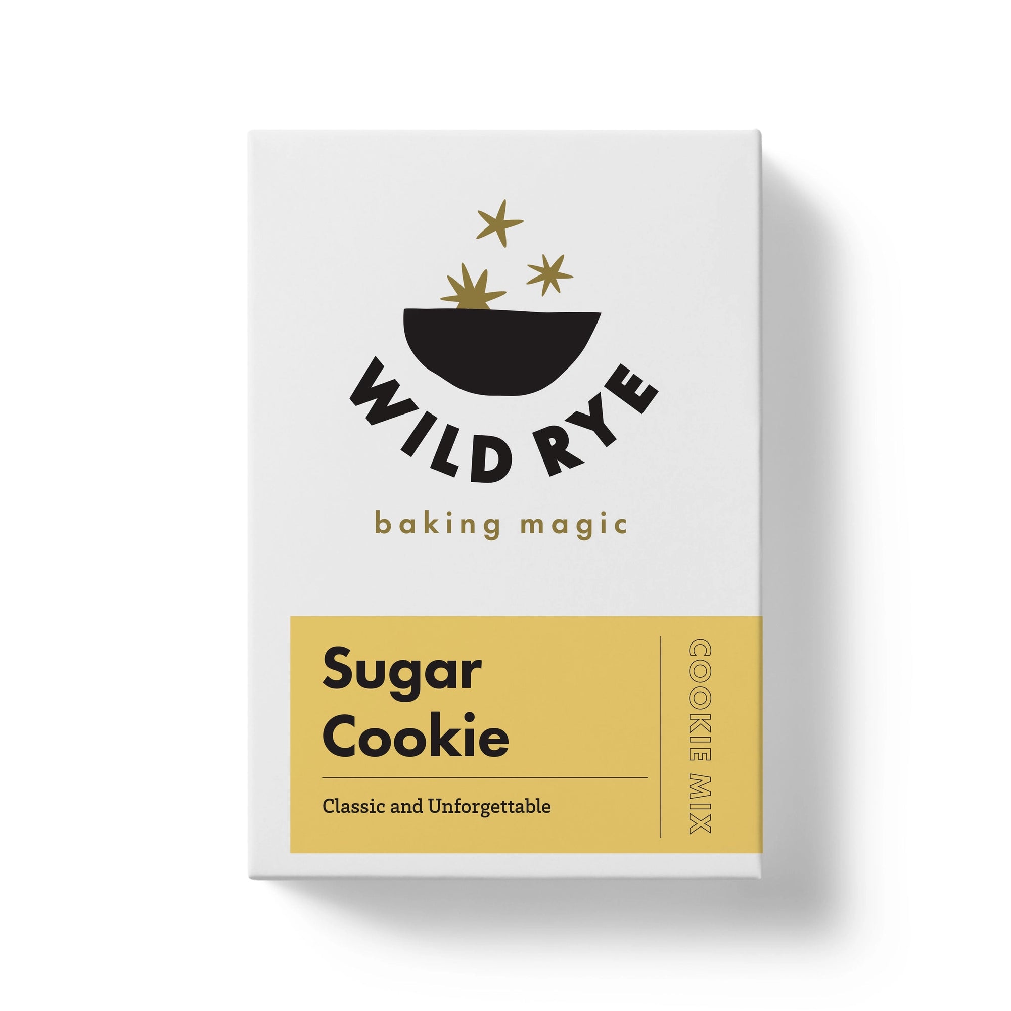 A box of Wild Rye Sugar Cookie Mix featuring a minimalist design with gold stars, a black bowl, and a yellow label reading "Sugar Cookie: Classic and Unforgettable," made with organic ingredients for delicious buttery cookies.