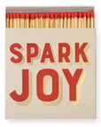 A partially open box of Faire's Matches/Square reveals red-tipped matches. The bold red and yellow "SPARK JOY" label makes it ideal for collectors who love unique matchbox designs.