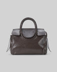 Dark brown snakeskin-embossed Staud Maude Mini Carryall with top handles and flap closure on light gray surface.