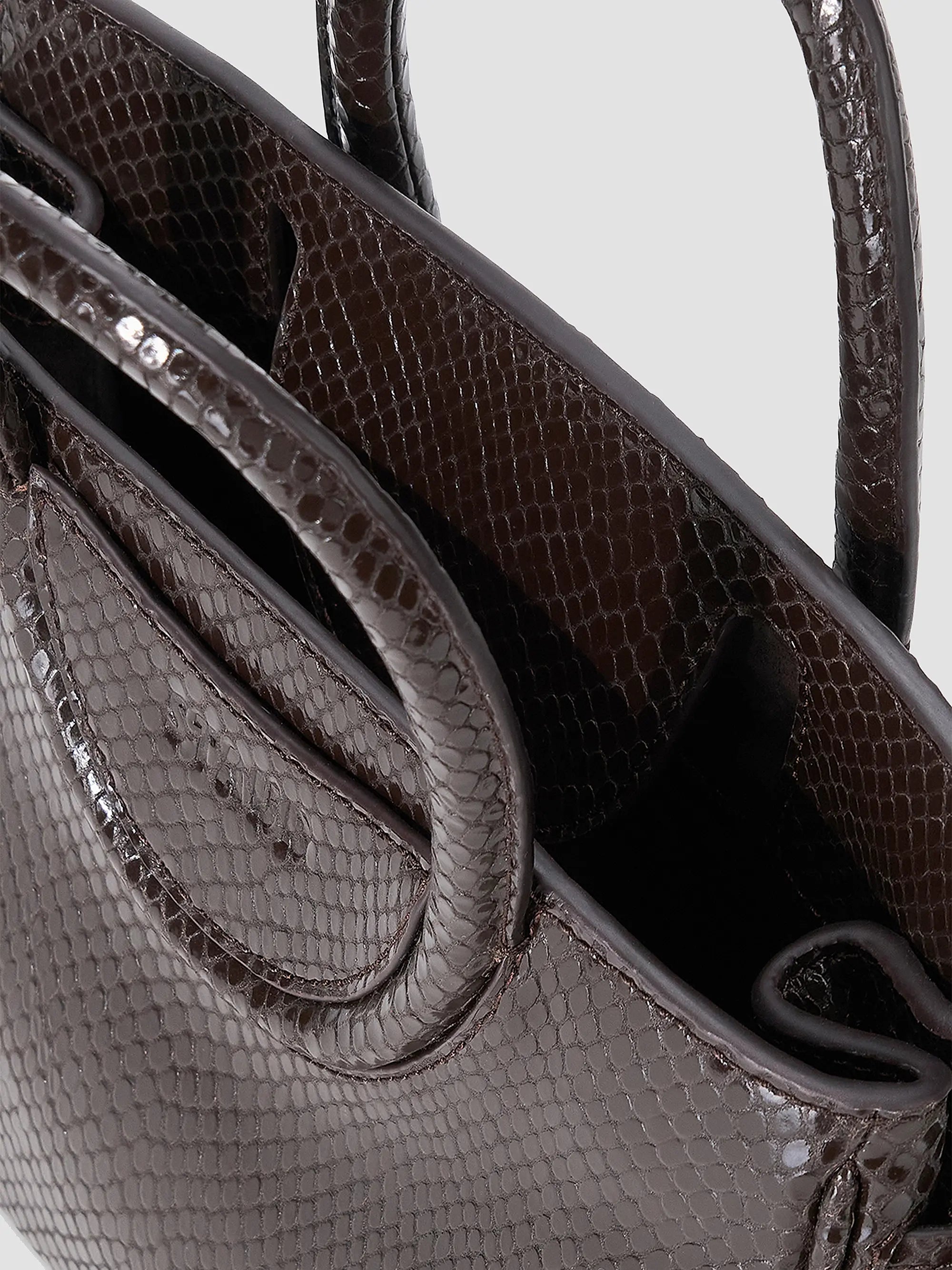 Staud Maude Mini Carryall in dark brown snakeskin-embossed leather with dual handles and open top.