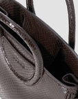 Staud Maude Mini Carryall in dark brown snakeskin-embossed leather with dual handles and open top.
