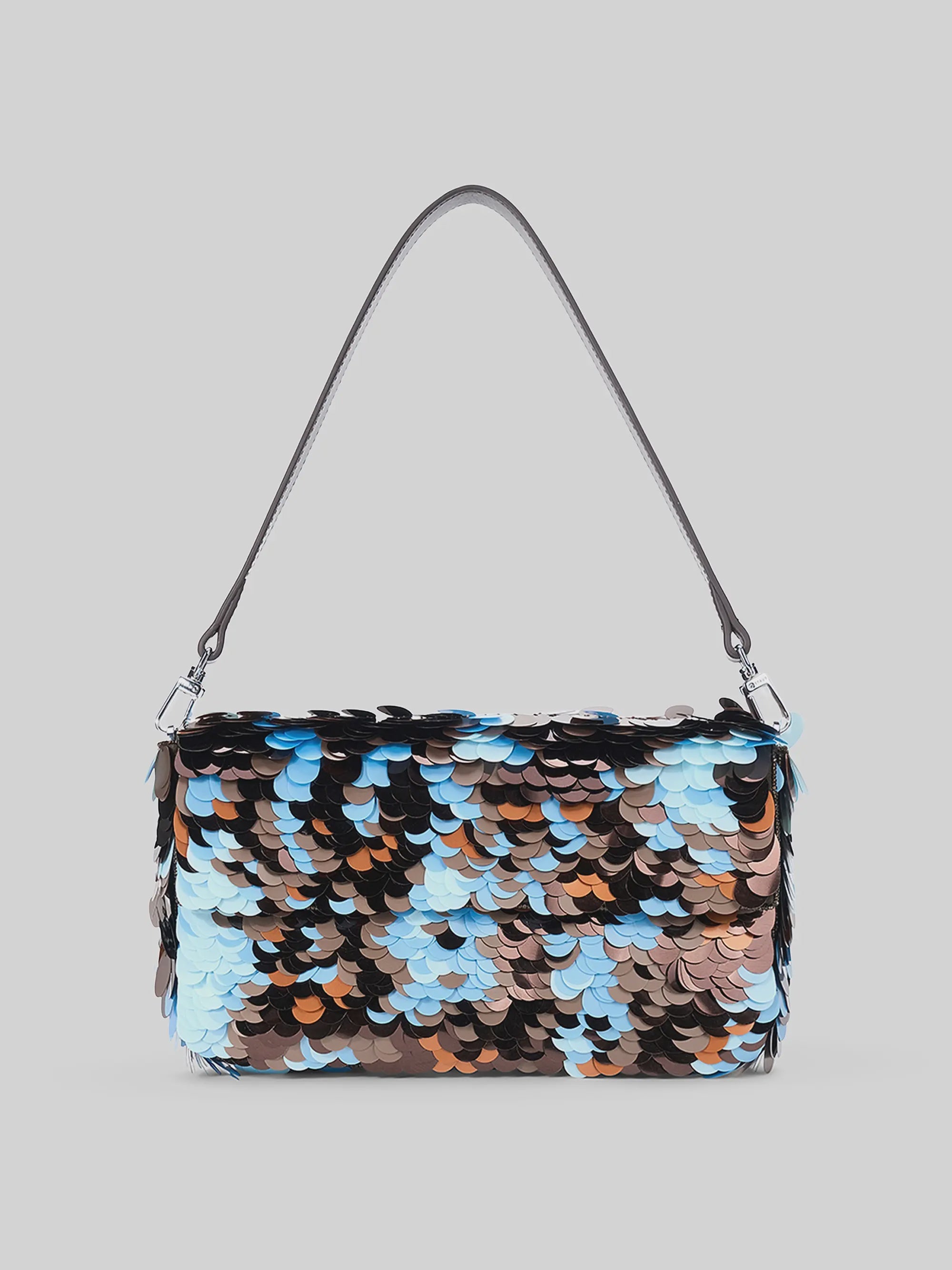 Staud Timmy Convertible Shoulder Bag with brown, blue, and silver paillettes on gray and a short strap.