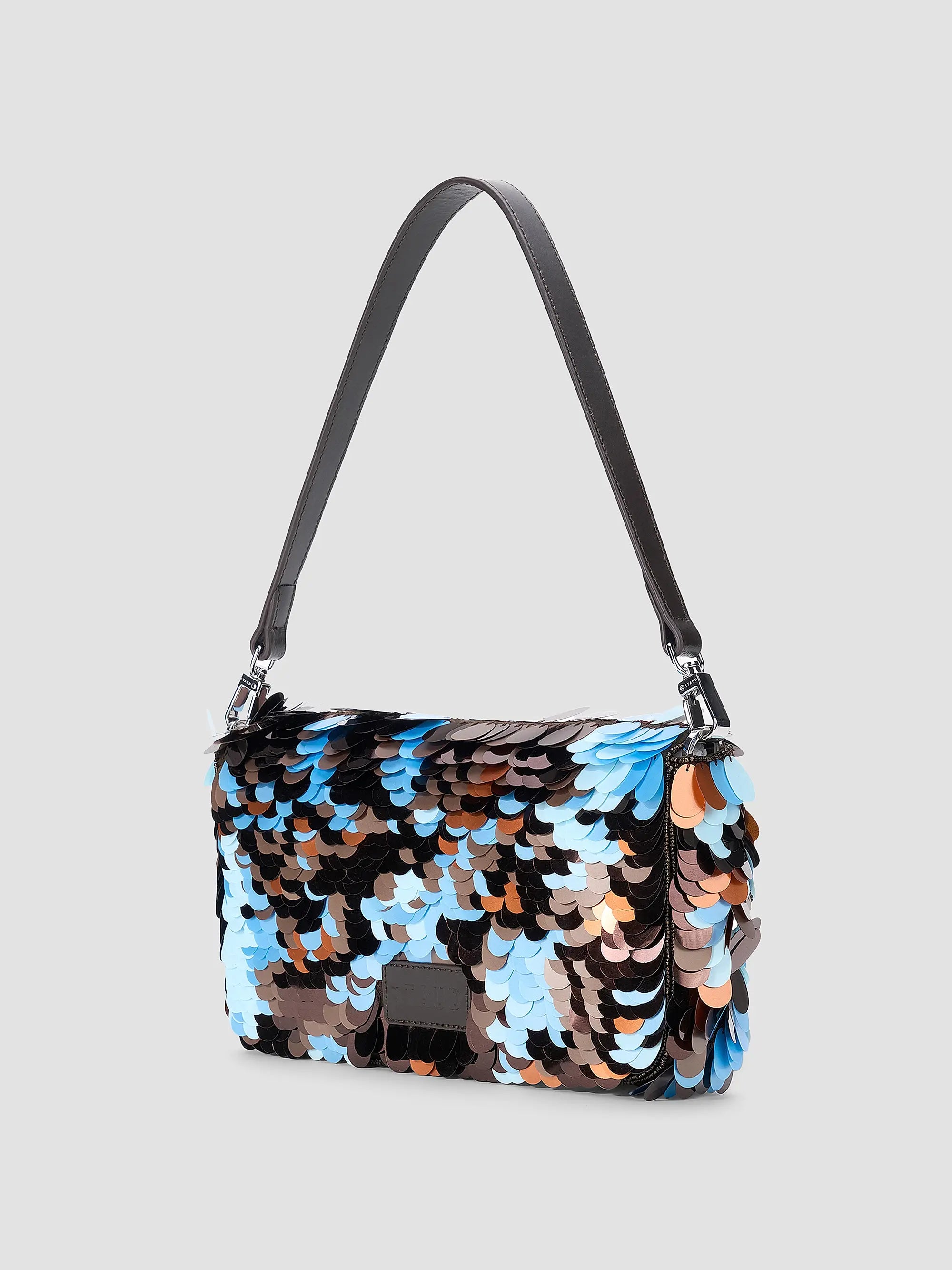 Black leather Staud Timmy Convertible Shoulder Bag with overlapping paillettes on a gray background.