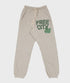 The Freecity Large Pocket Sweatpant by Free City (sparrow, LLC) features a beige drop crotch design with elastic waistband and cuffs, cream drawstring, and green "FREE CITY" text with bird graphic—an effortless style essential.