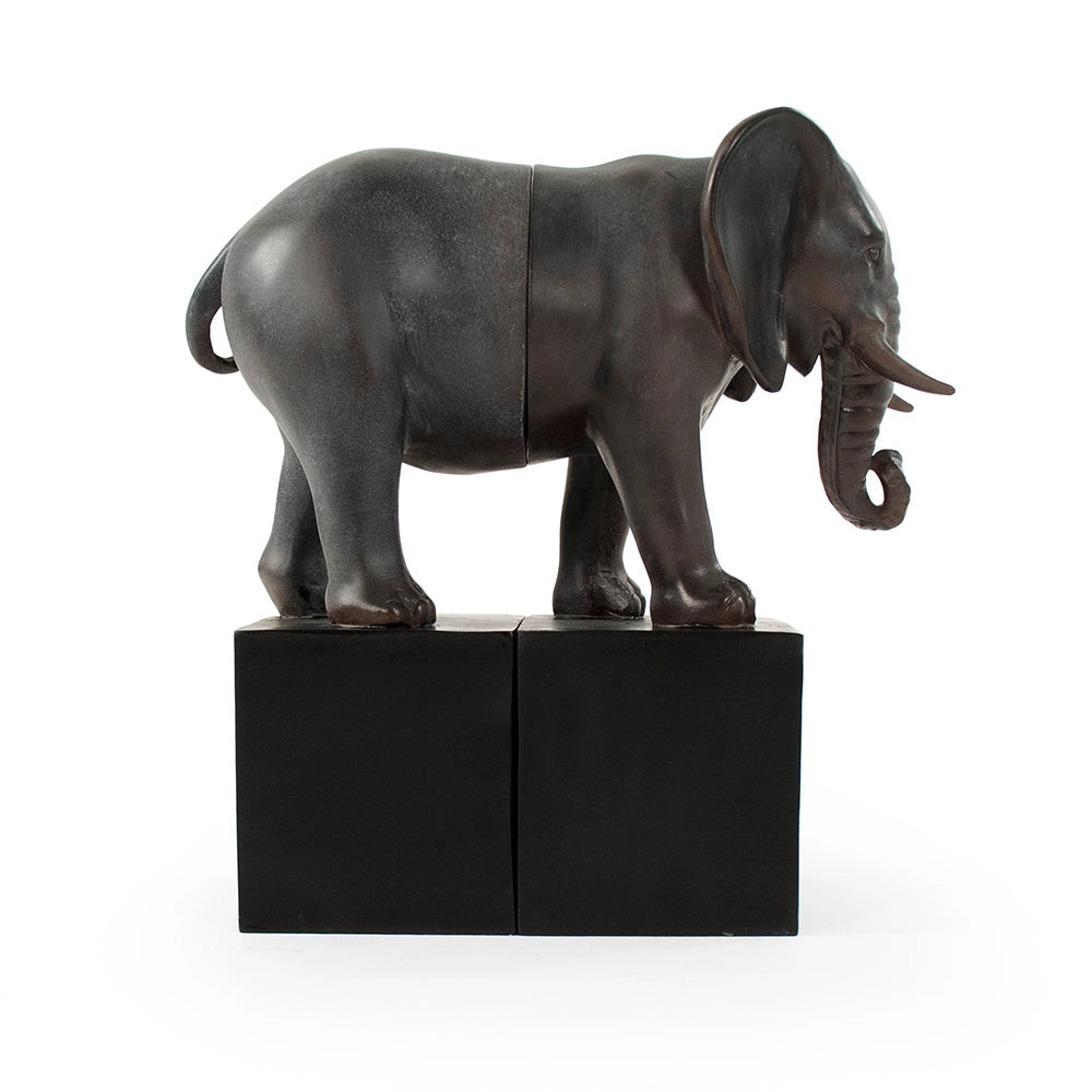 The Zentique Elephant Bookends feature a realistic elephant sculpture split in two, each half mounted on a black block. This decorative set creates a striking, visually connected display against any plain white background.