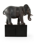 The Zentique Elephant Bookends feature a realistic elephant sculpture split in two, each half mounted on a black block. This decorative set creates a striking, visually connected display against any plain white background.