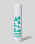 Against a gray background, a white tube of "Faire All Balm Stick" features bold green text: "Spearmint Menthe Verte." This 0.5 oz/15 g balm provides non-greasy hydration for lips, hands, and body with natural ingredients.