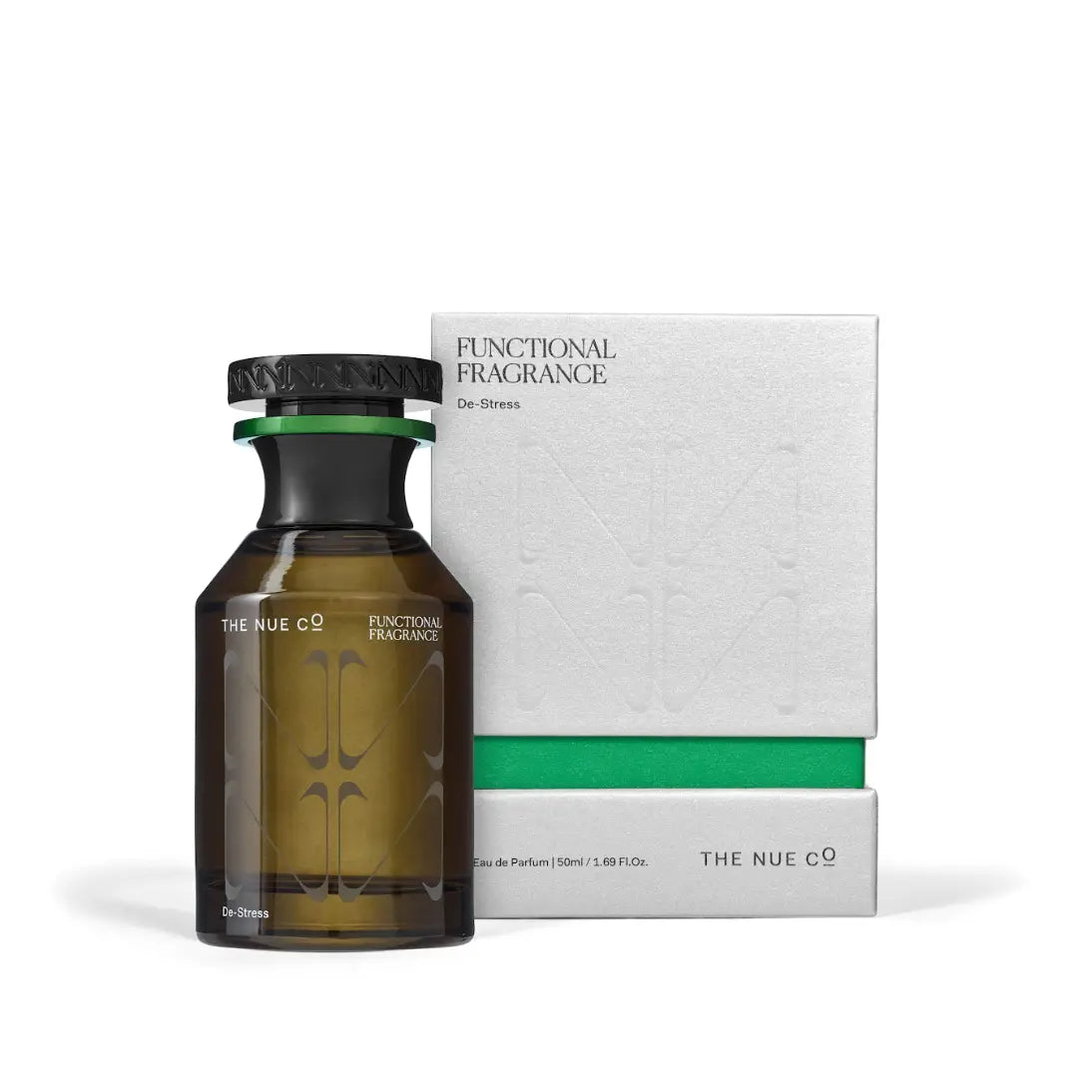 A brown glass bottle of The Nue Co Functional Fragrance 50ML, created to help de-stress, is placed beside its white and green box labeled "De-Stress" and "Eau de Parfum 50ml.