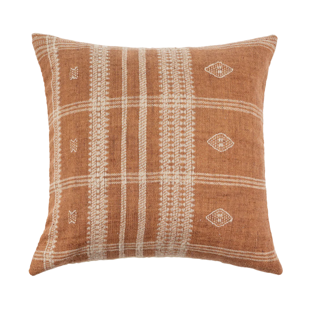 The Bhujodi Wool Pillow by Indaba is a 20-inch decorative cushion with a woven texture, featuring a warm brown background and cream geometric patterns like stripes, diamonds, and small crosses.