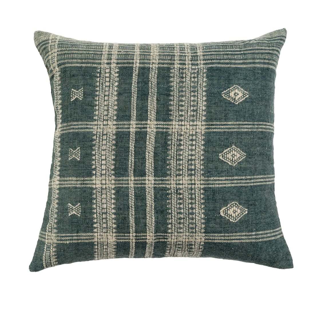 The Bhujodi Wool Pillow by Indaba is a 20-inch decorative cushion with a dark green background, cream geometric patterns—lines, diamonds, and crosses—and textured woven stripes for added visual appeal.