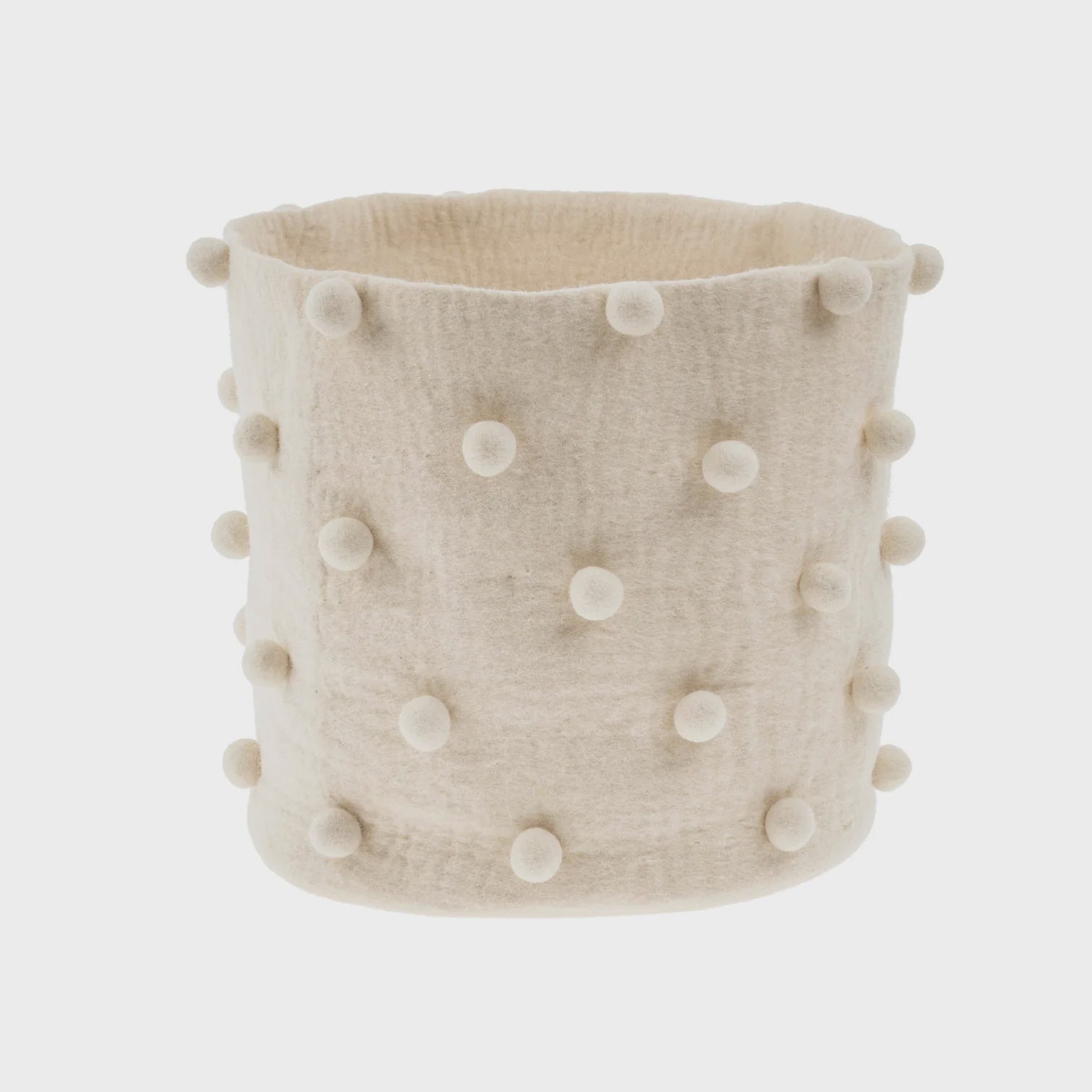 A beige, cylindrical Felted Pom Pom Basket S by Indaba is crafted from felt and adorned with evenly spaced, soft, round pom-poms on its surface. This fair trade item is showcased against a plain white background.