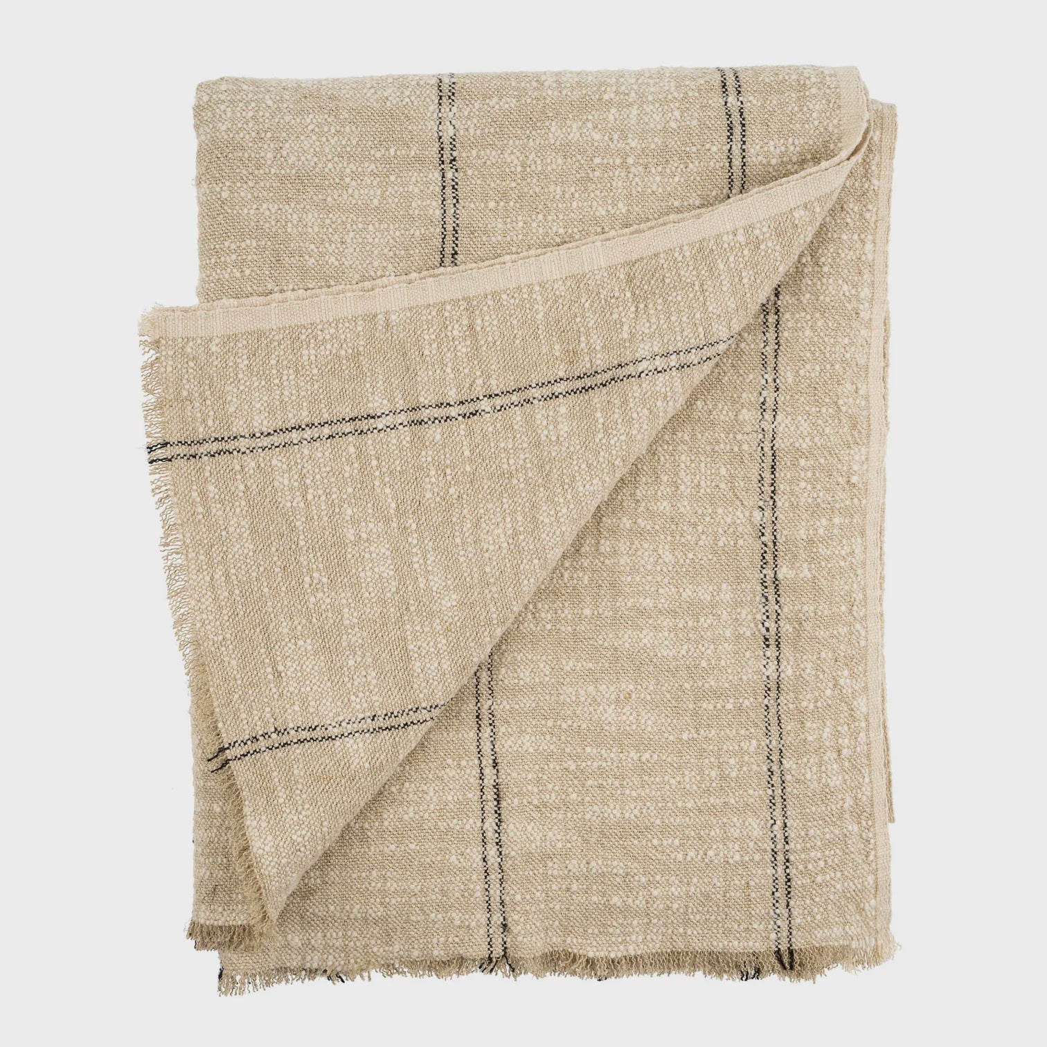 The Solace Slub Linen Throw by Indaba, featuring a beige slub texture with delicate black stripes, is artfully folded to reveal a flipped corner. Its slightly rough, woven finish adds to its rustic charm against the plain white background.