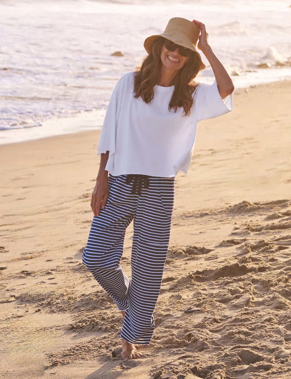 Frank &amp; Eileen Presley Oversized Tee in white, casual beachwear style, worn barefoot by the water.