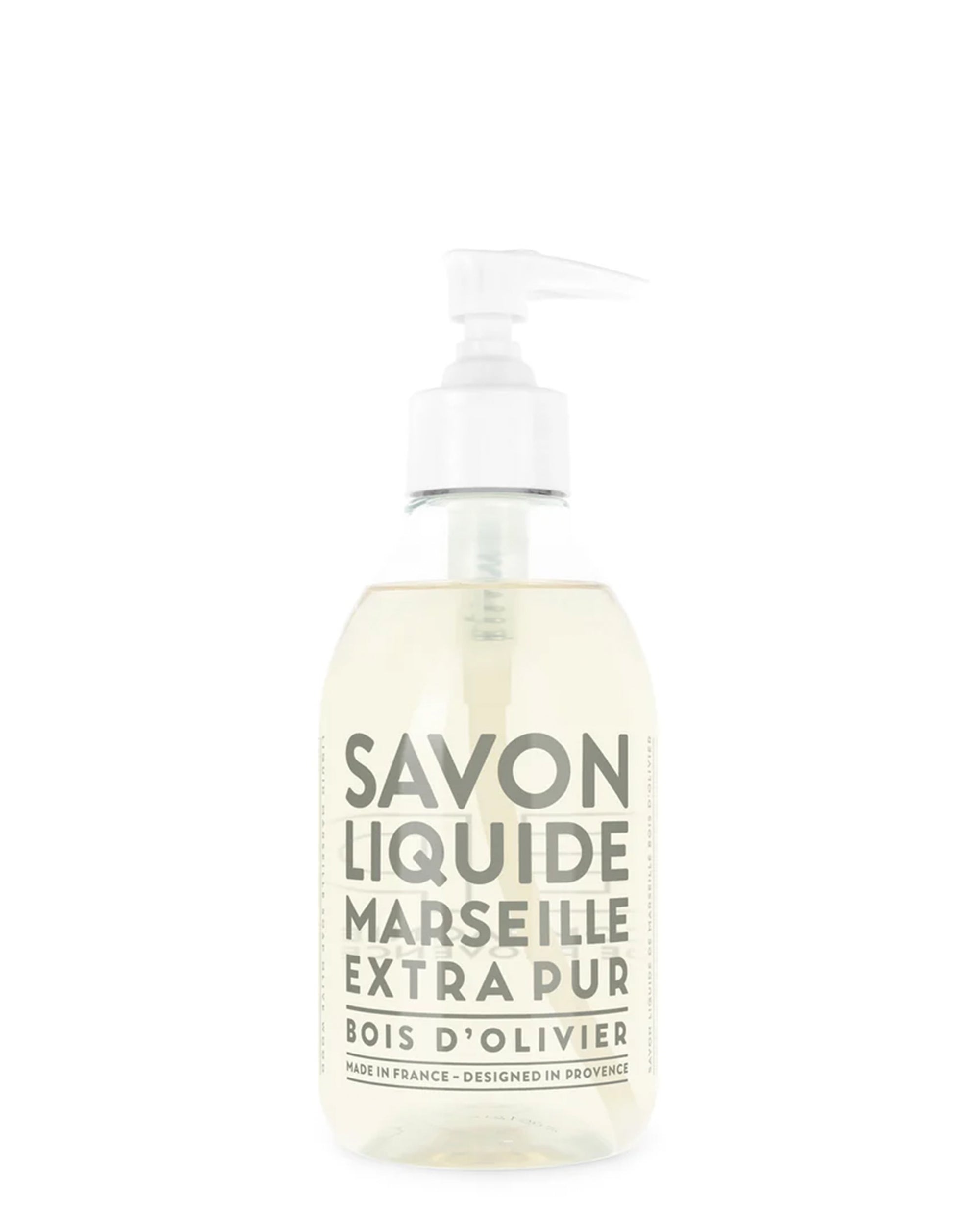 A clear recyclable plastic bottle of Cie Luxe Brands Liquid Soap 10oz, made from vegetable oils with a Bois d’Olivier scent. The label is white with gray text and the light yellow soap shows through.