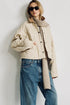 Denimist Faulkner quilted jacket with knit scarf, styled casually outdoors by a white wall.
