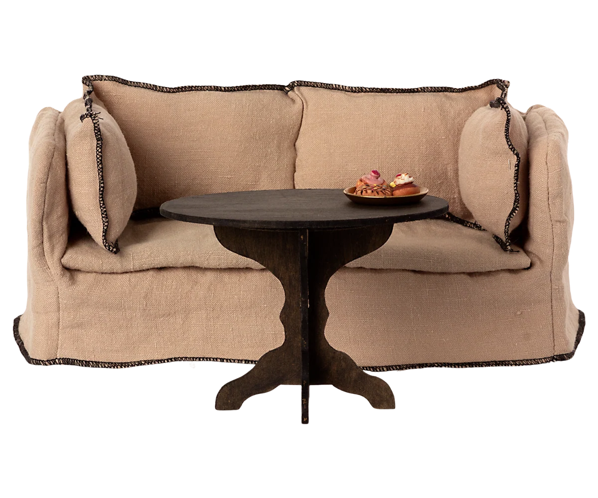 Maileg Coffee Table Miniature with pastries, cozy living room setting, beige loveseat in background.