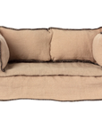 The Maileg Couch, Miniature by Maileg is a small beige sofa with two matching cushions and dark trim, shown from the front on a plain white background—ideal dollhouse furniture.