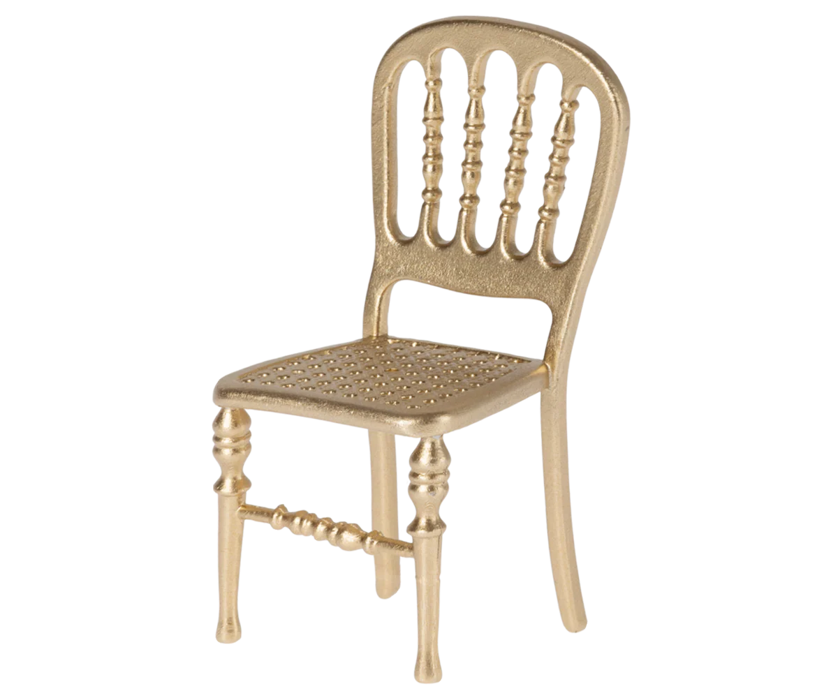 The Maileg Furniture gold-colored chair by Maileg features a decorative spindle-style backrest, perforated seat, and ornate legs—ideal for dollhouses or your Maileg Mouse.