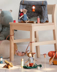 A whimsical camping scene: hiker mice relax in a tent, with Maileg Thermos & Cups by Maileg, lanterns, a bonfire, plush animals, and more on a light wooden floor.