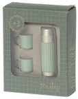 The Maileg Thermos & Cups set features a green and silver thermos and two green mugs for hiker mice, packaged in a windowed box with a grid pattern and the Maileg brand name on the front.