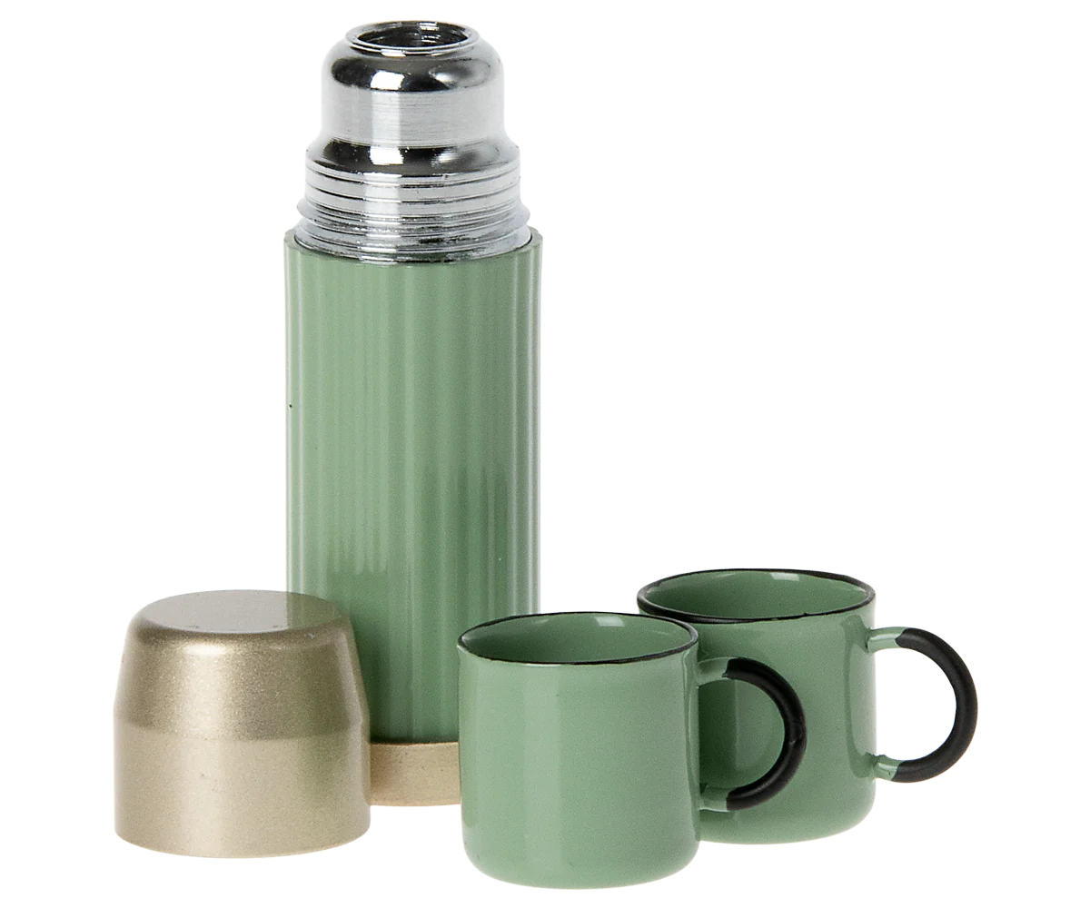 A stylish green Maileg Furniture thermos by Maileg, featuring a metallic lid, matching cap, and two green cups with black handles—perfect for dollhouse play—displayed on a white background.