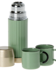 A stylish green Maileg Furniture thermos by Maileg, featuring a metallic lid, matching cap, and two green cups with black handles—perfect for dollhouse play—displayed on a white background.