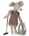 A Maileg stuffed mouse in a striped dress holds the hose of a Maileg Vacuum Cleaner toy, ready to clean. The soft mouse features fabric ears and a stitched nose, with the vacuum cleaner standing beside it.