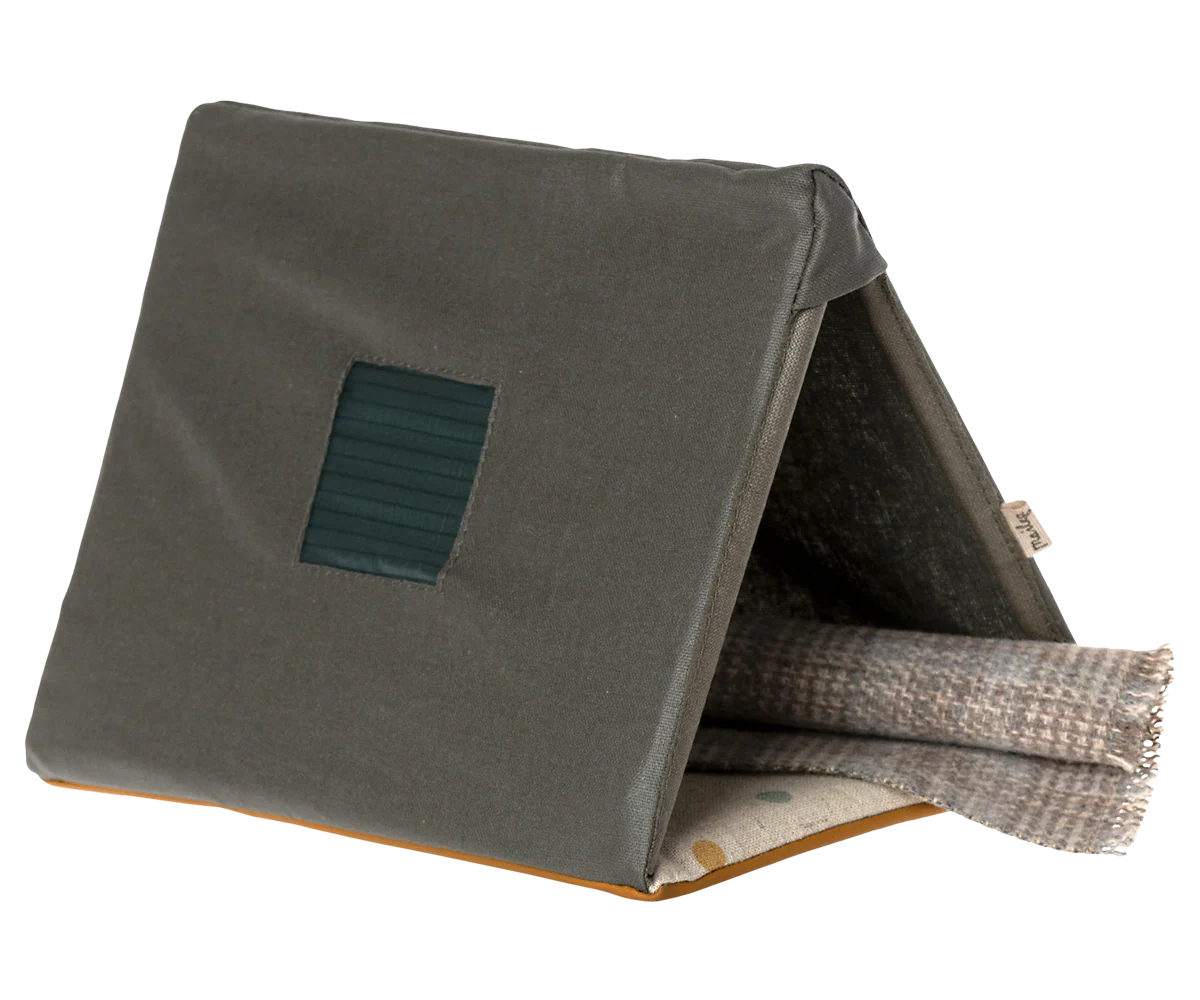 The Maileg Furniture by Maileg is a cute, triangular tent-shaped pet bed with a green exterior and brown base, featuring a front opening and soft blanket—ideal for Maileg Mouse or dollhouse setups.