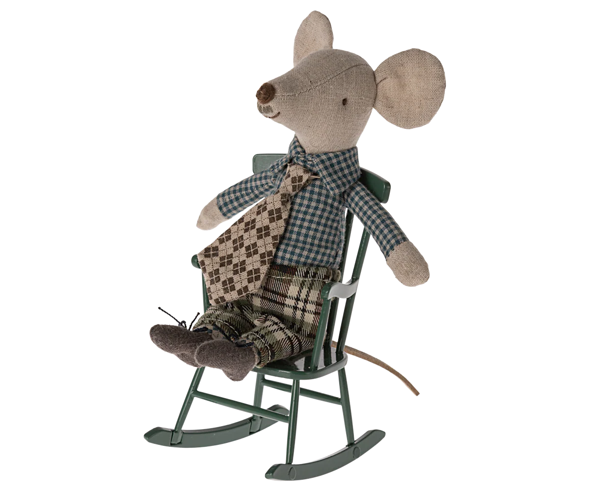 A Maileg fabric mouse doll with large ears, plaid shirt, patterned tie, and checkered pants sits in the Maileg Rocking Chair—a charming accent for your living room décor.